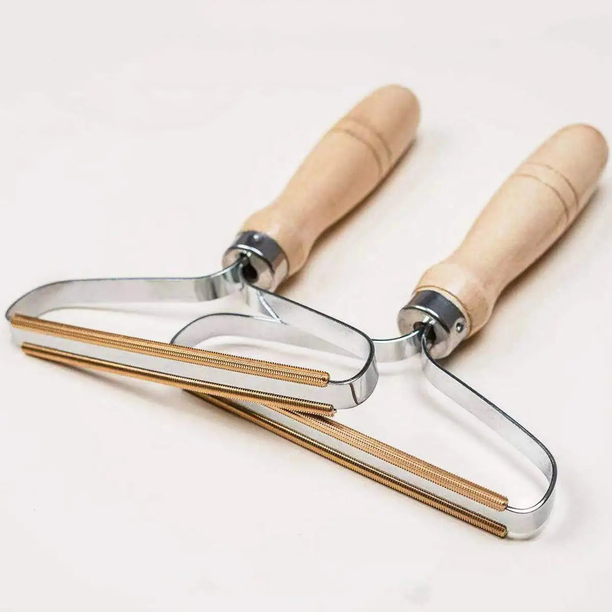 Metal lye with wooden handles on a white background